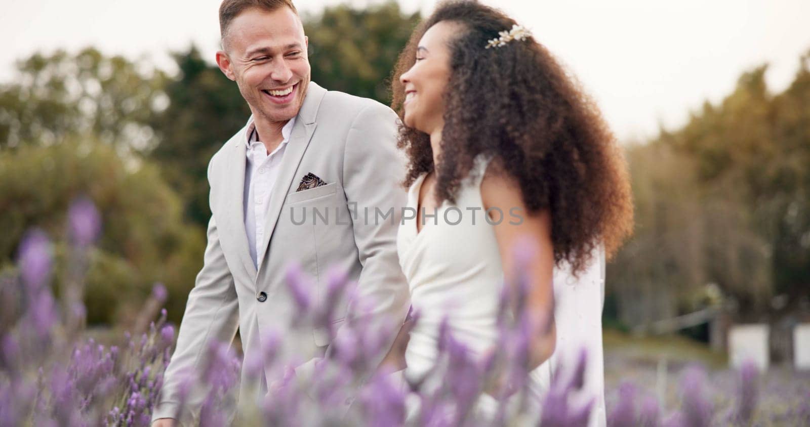 Wedding, walking and field with couple, marriage and funny with love, commitment and happiness. Happy people, bride and groom outdoor, romance and countryside with trust, bonding and conversation by YuriArcurs