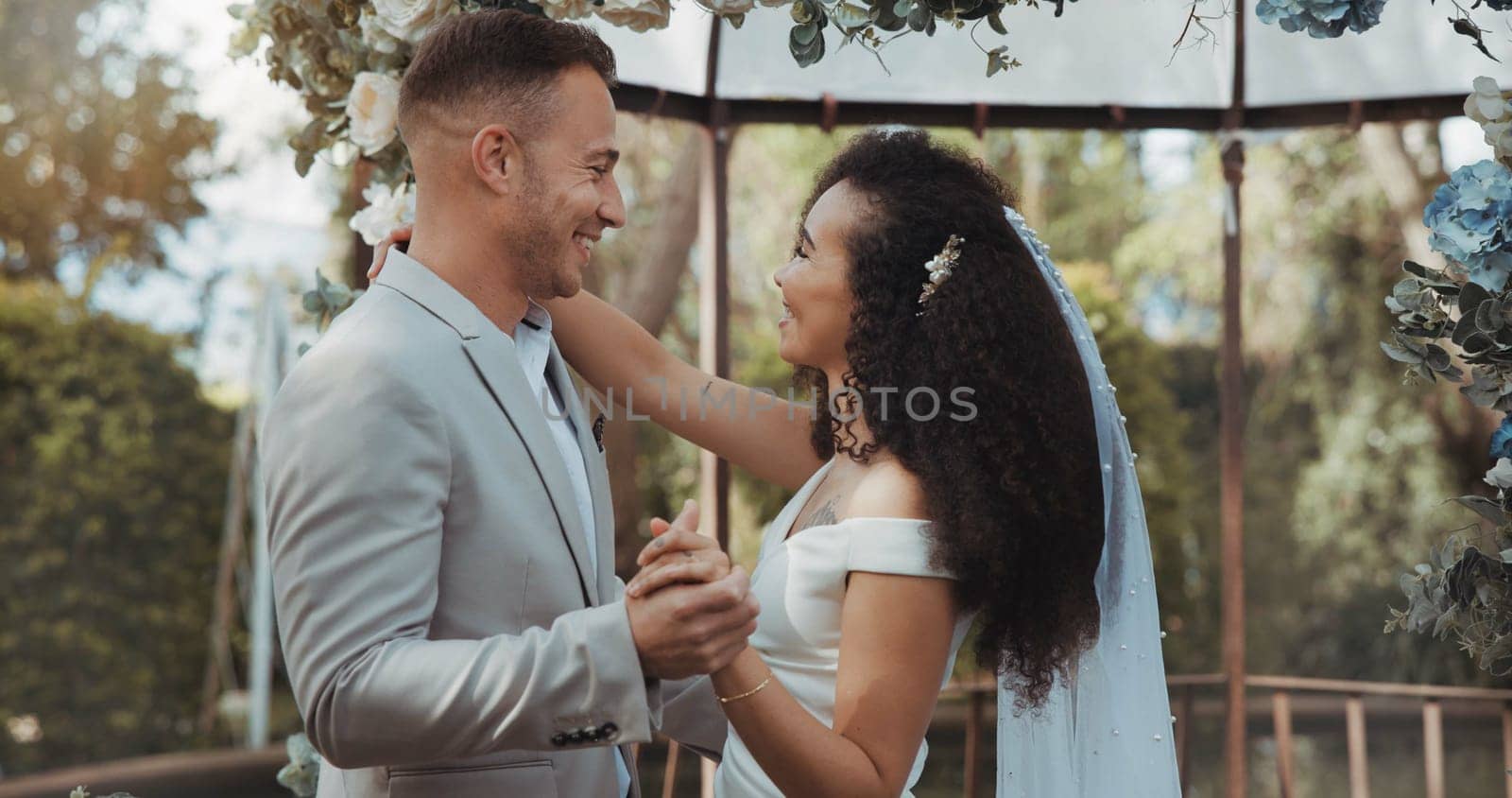 Couple, wedding and dancing with touch, smile and commitment in celebration. Interracial marriage, fashion and happy in outdoor, love and romance in conversation, trust and vertical in nature or cute.