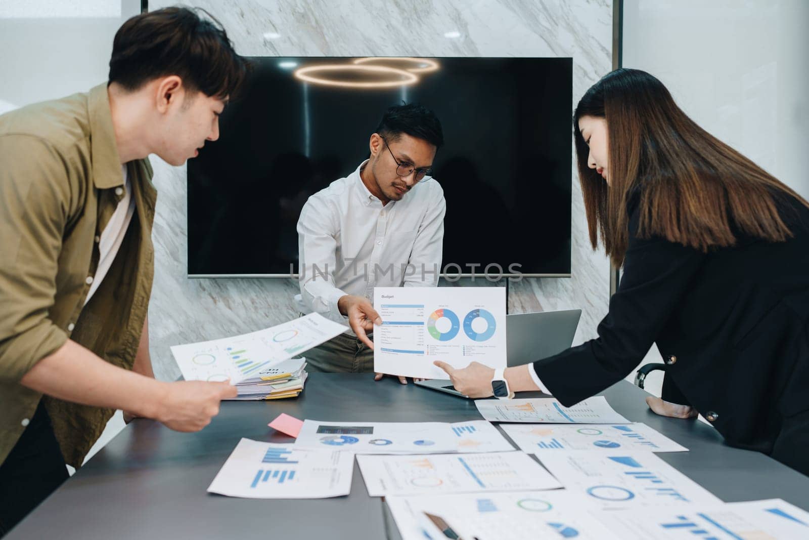 Asian business advisor meeting to analyze and discuss the situation on the financial report in the meeting room.Investment Consultant, Financial , teamwork ,brainstorming ,startup and accounting.