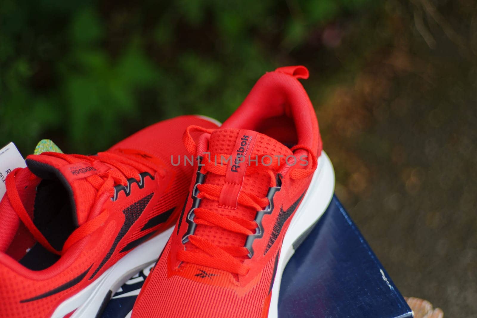 Tyumen, Russia-June 20, 2024: Reebok red sneakers logo. Reebok is a global athletic footwear