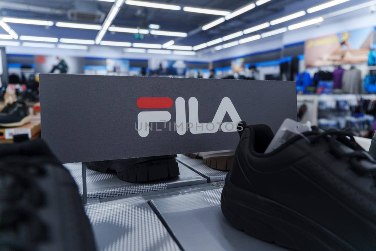 Tyumen, Russia-August 11, 2024: Fila sneaker is prominently displayed with detailed lacing and a visible brand tag, viewed inside a retail shop.