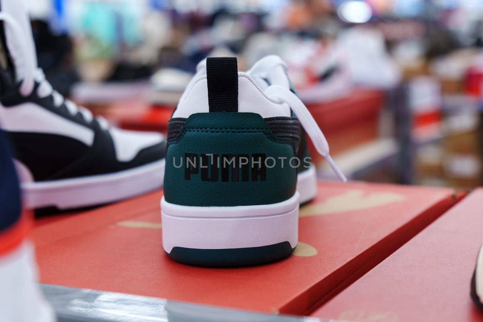 Tyumen, Russia-August 11, 2024: Trendy athletic shoe Puma is prominently showcased in a retail setting, highlighting its unique color combination and design