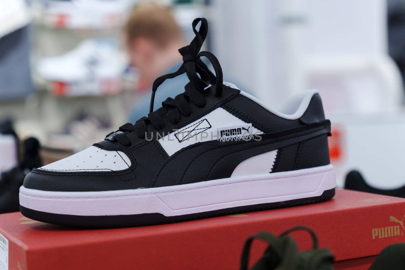 Tyumen, Russia-August 11, 2024: Stylish athletic shoe Puma displayed in a retail store with a modern design and vibrant colors