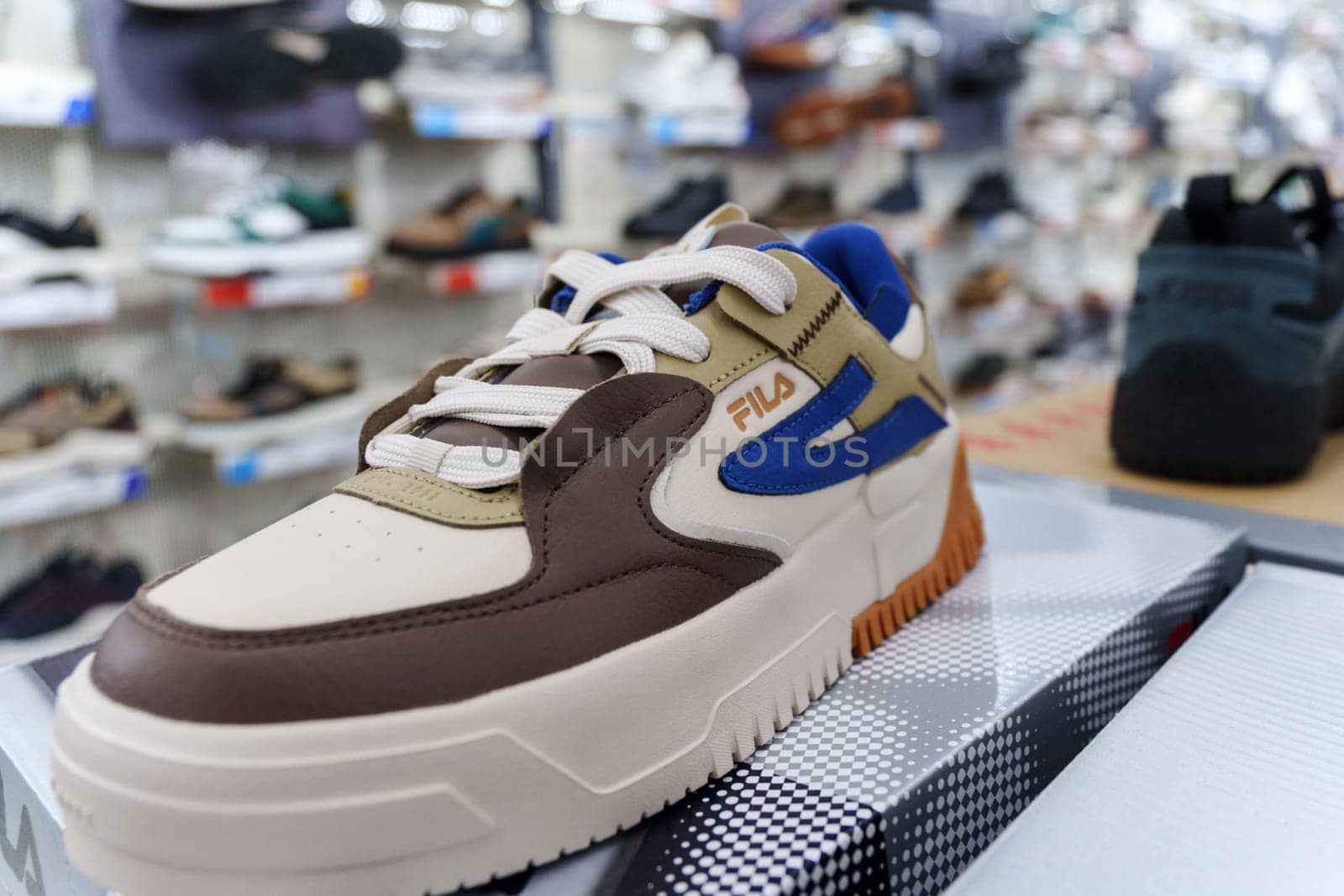 Tyumen, Russia-August 11, 2024: Close-up of a Fila sneaker showcasing the intricate lacing and design in a retail store