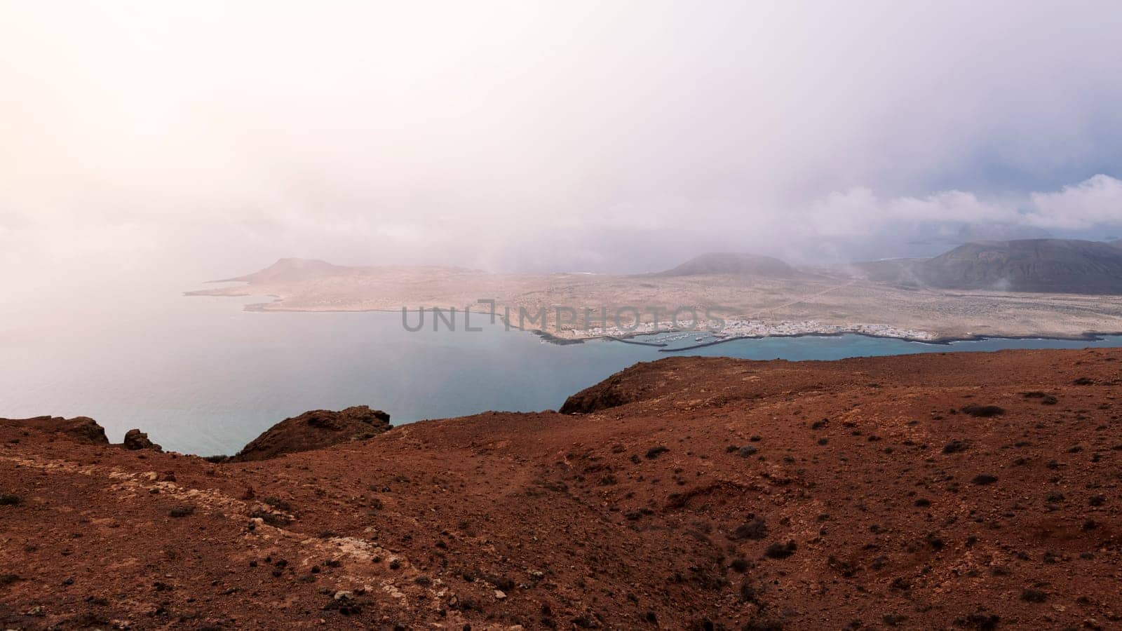 picturesque view of Graciosa island with volcanic mountains at sundown in Teguise, Lanzarote at Canari Islands in Spain, concept of nature and volcanic landscape