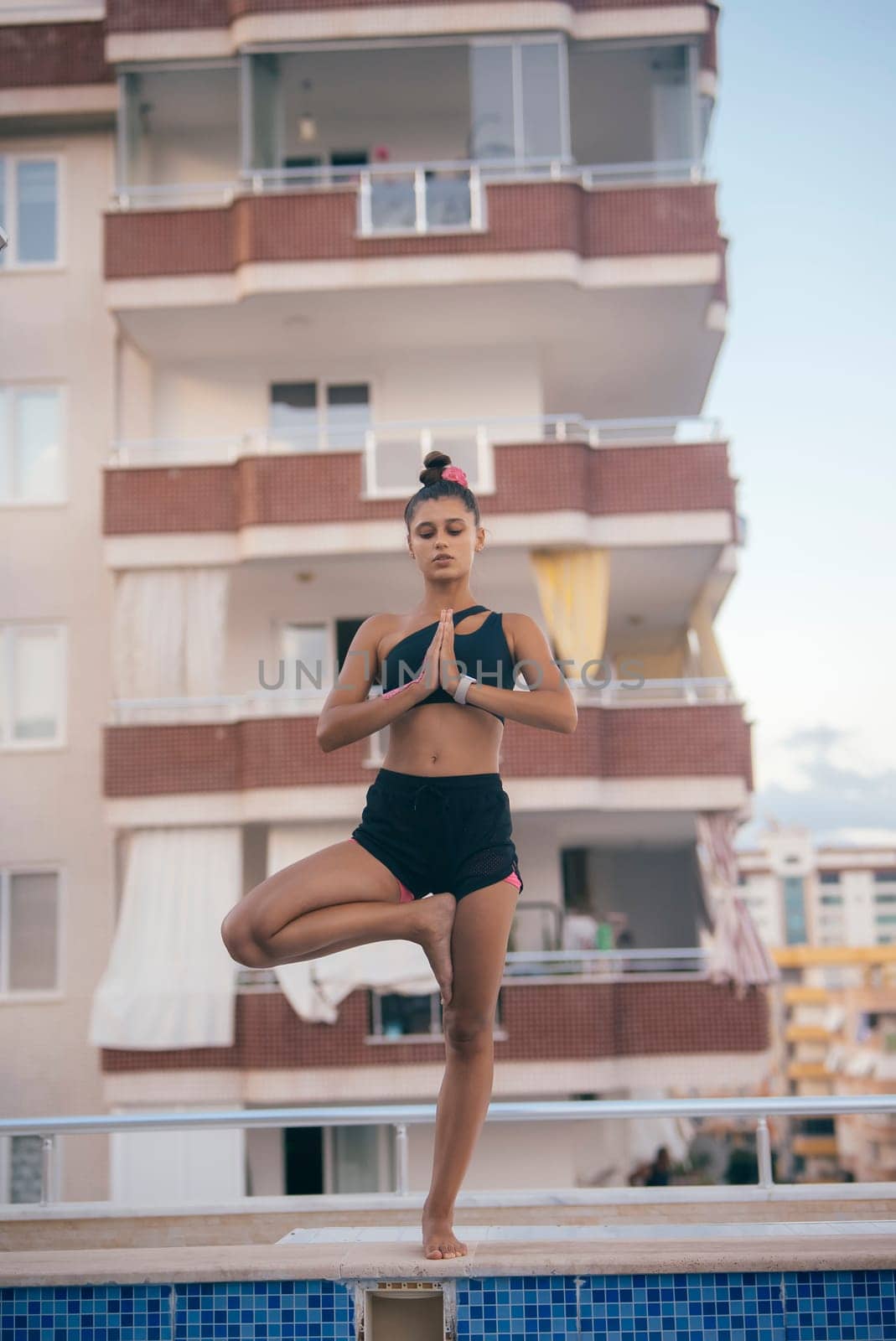 A calming and serene moment for meditation and balance, beautifully showcasing yoga performed near a tranquil pool