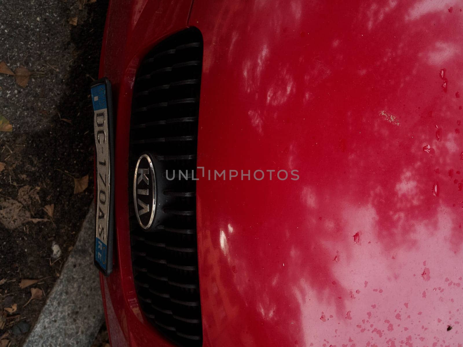 Cremona, Italy September 26th 2024 Red car parked on the side of a street, with KIA brand logo visible on the front grill