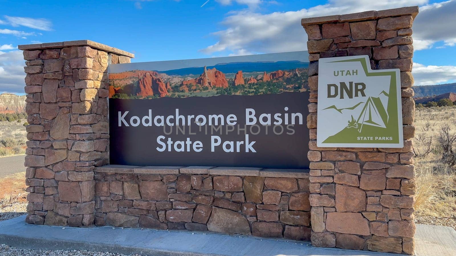 Cannonville, Utah, USA - 03/18/2024: Kodachrome Basin State Park entrance sign in Utah, USA. The sign is made of stone and has a brown background with white lettering.