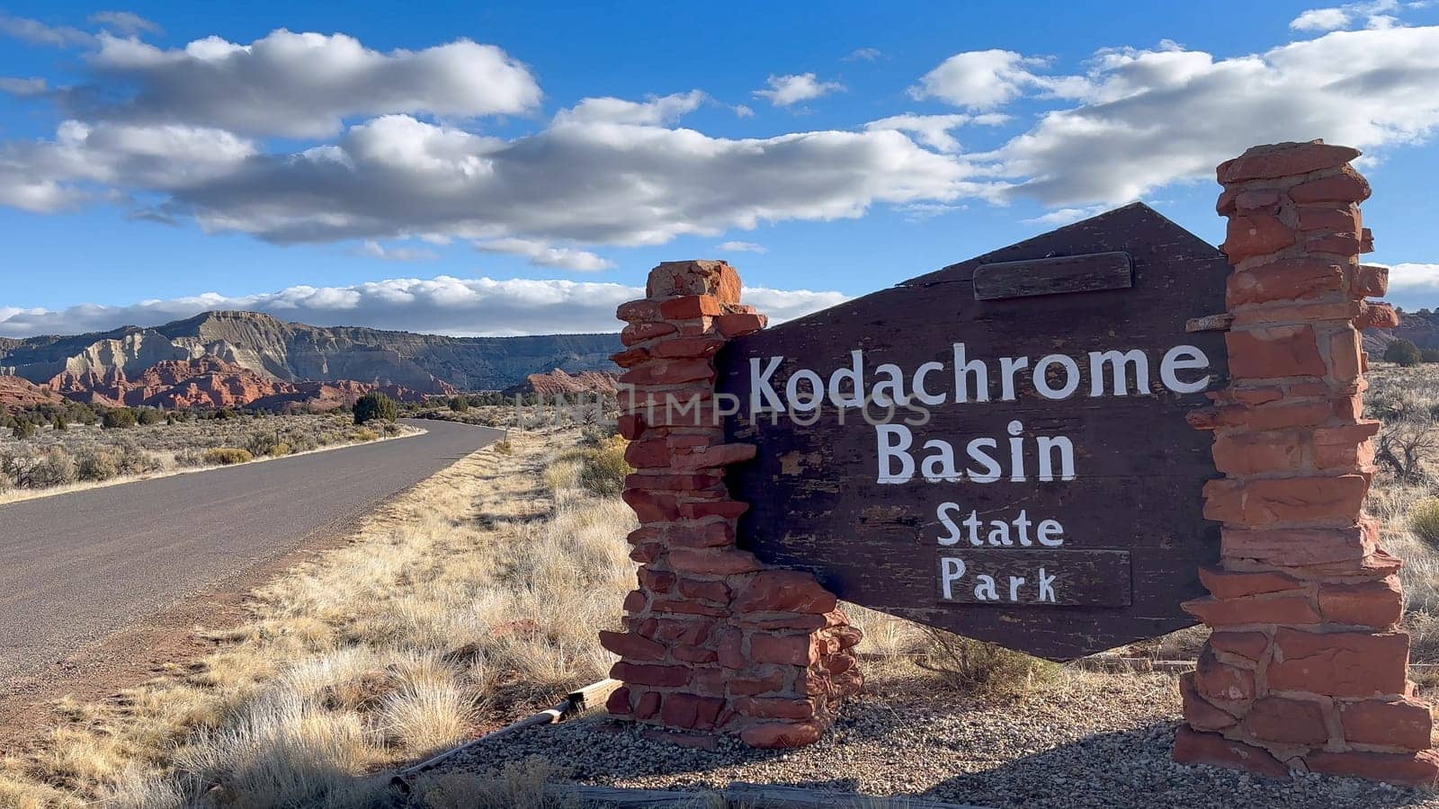 Cannonville, Utah, USA - 03.18.2024: Scenic view of the entrance sign to Kodachrome Basin State Park. The sign is made of wood and stone and is surrounded by stunning desert landscape.