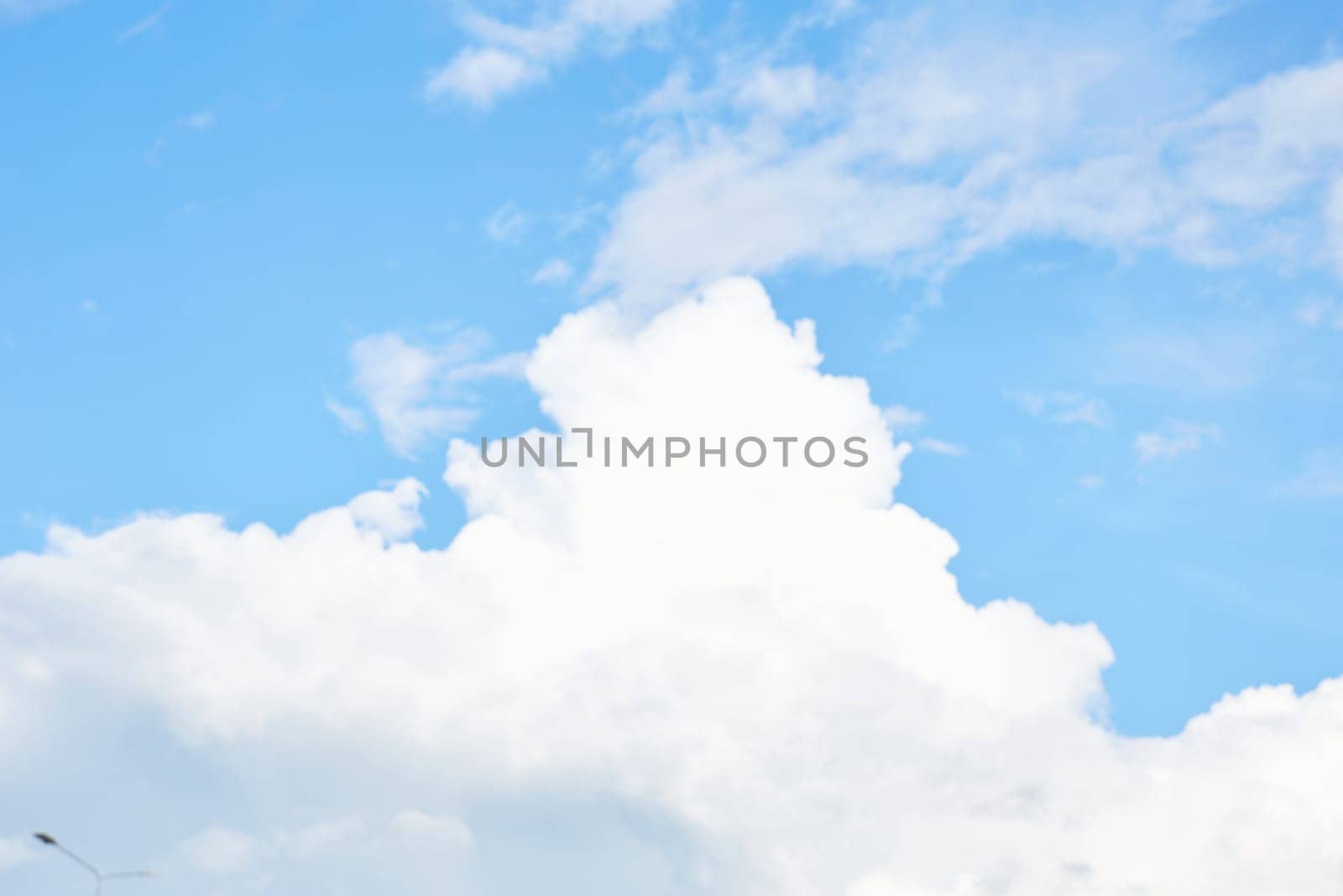 Bright blue sky with white clouds. Serene and calm. Banner background, backdrop, or texture.