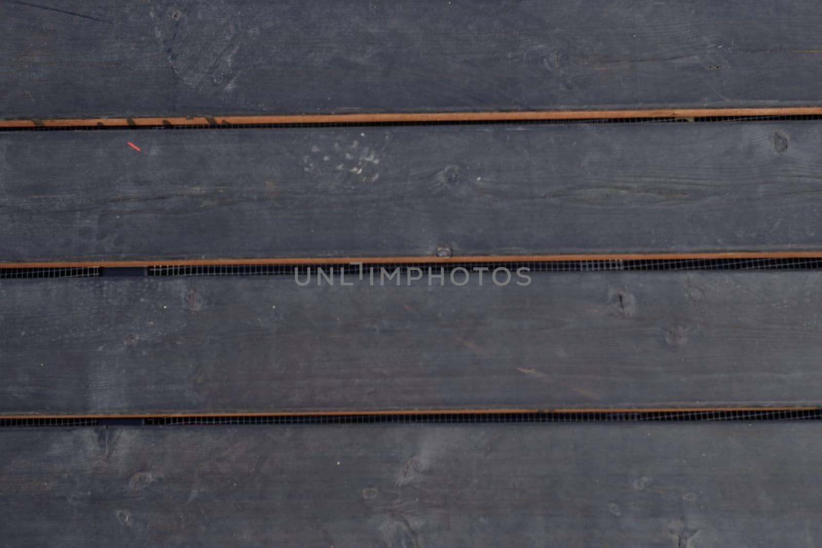 The texture of the board is made of ebony. The background is made of dark wood. Natural material.