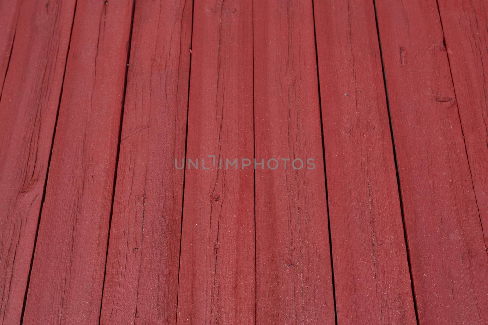 The background texture is a vertical red floorboard. Natural material. Construction and renovation.