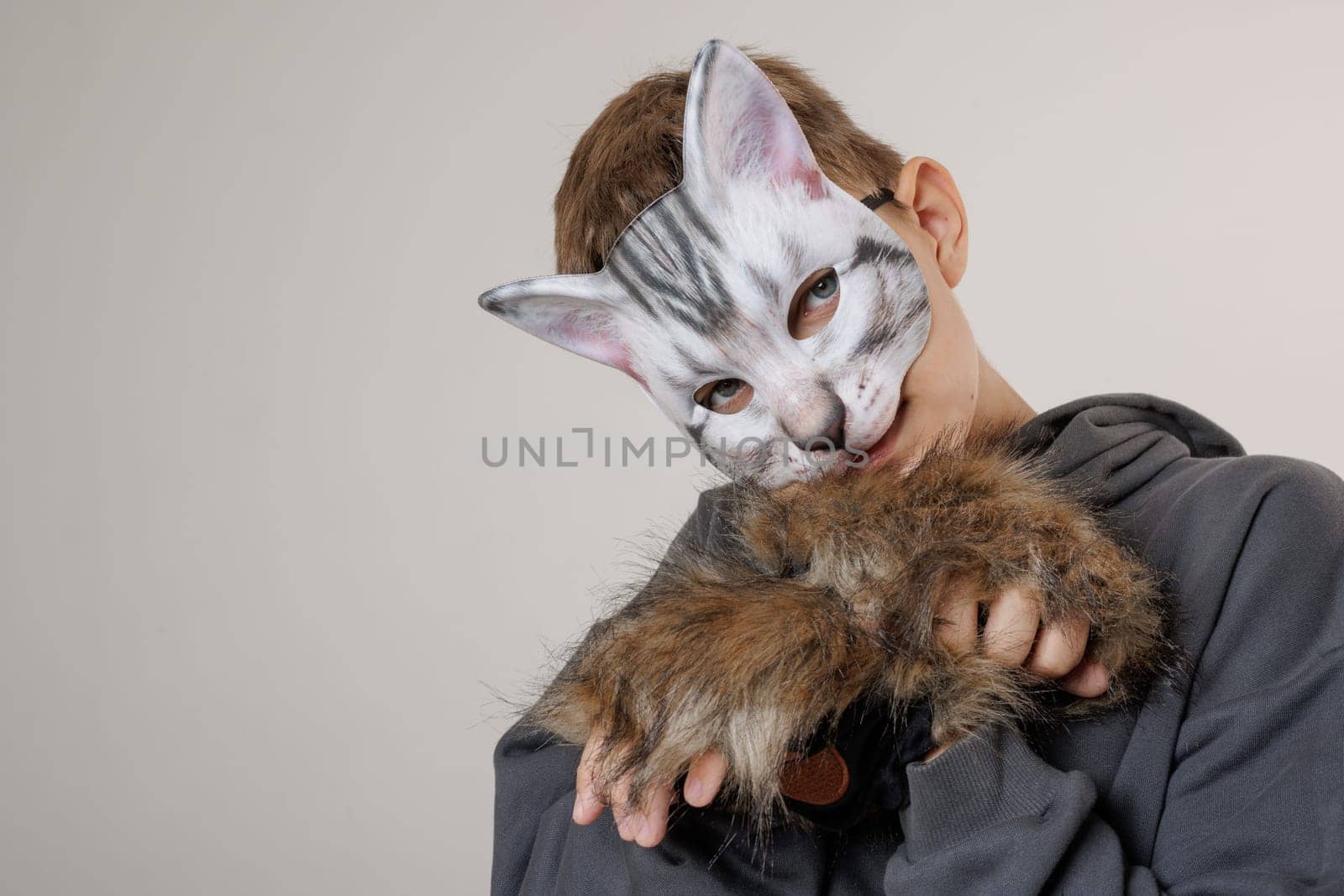portrait quadrobics Teenager in cat mask on gray background , studio photo , imitating cat movements, Quadrobics - Sport