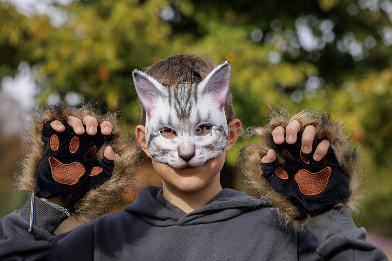 Teenager in a cat mask and gloves doing Quadrobics . aggressive Teenager in a Quadrobics mask jumps like a cat, Quadrobics - Sport