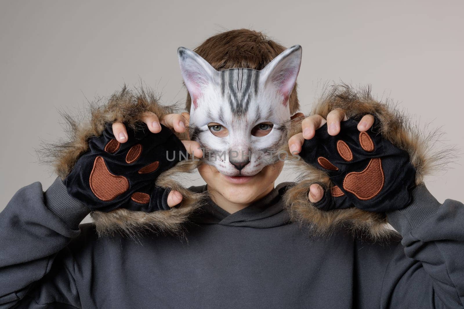 portrait quadrobics Teenager in cat mask on gray background , studio photo , imitating cat movements, Quadrobics - Sport