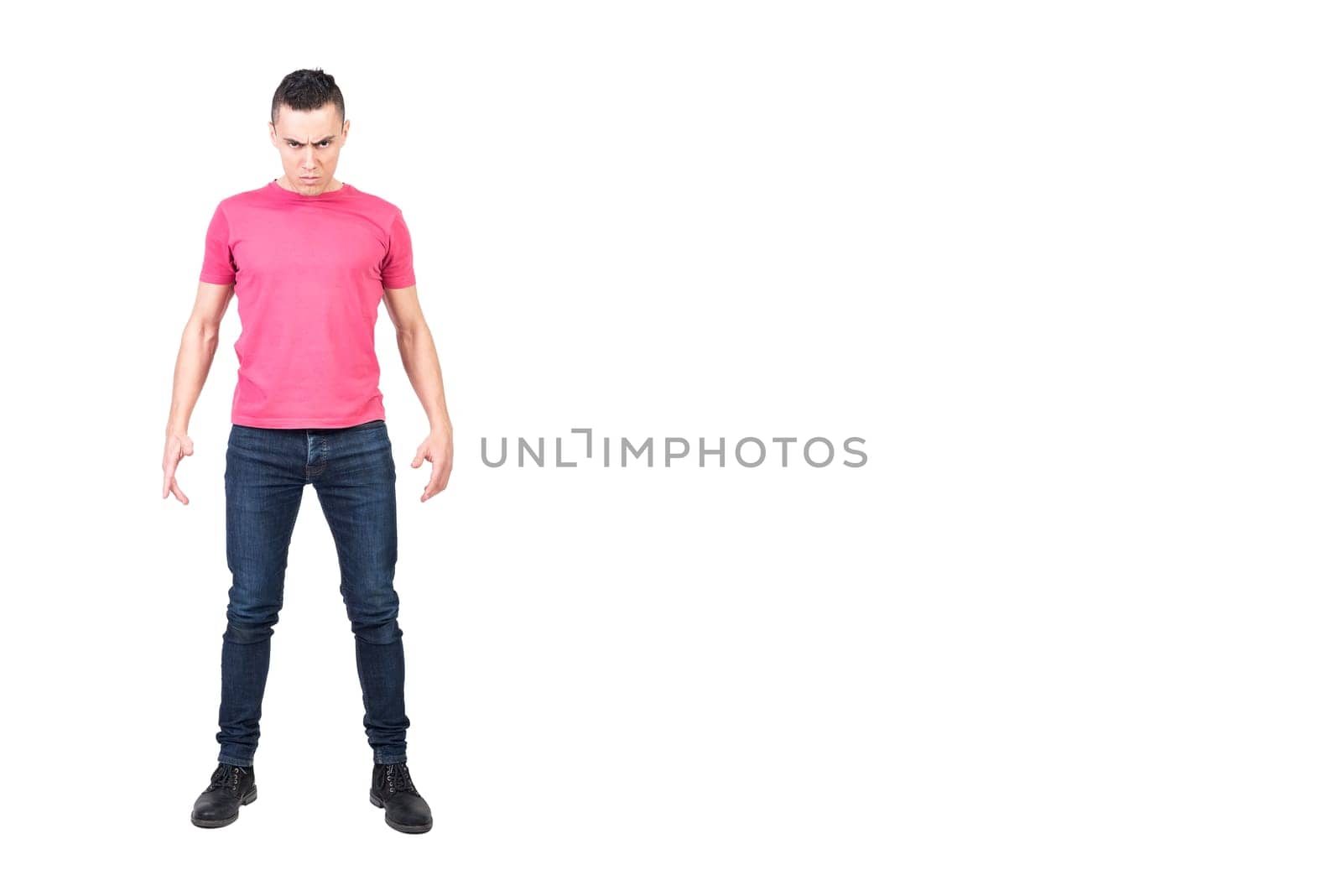 Full body male bully in casual clothes frowning and looking at camera while initiating conflict against white background