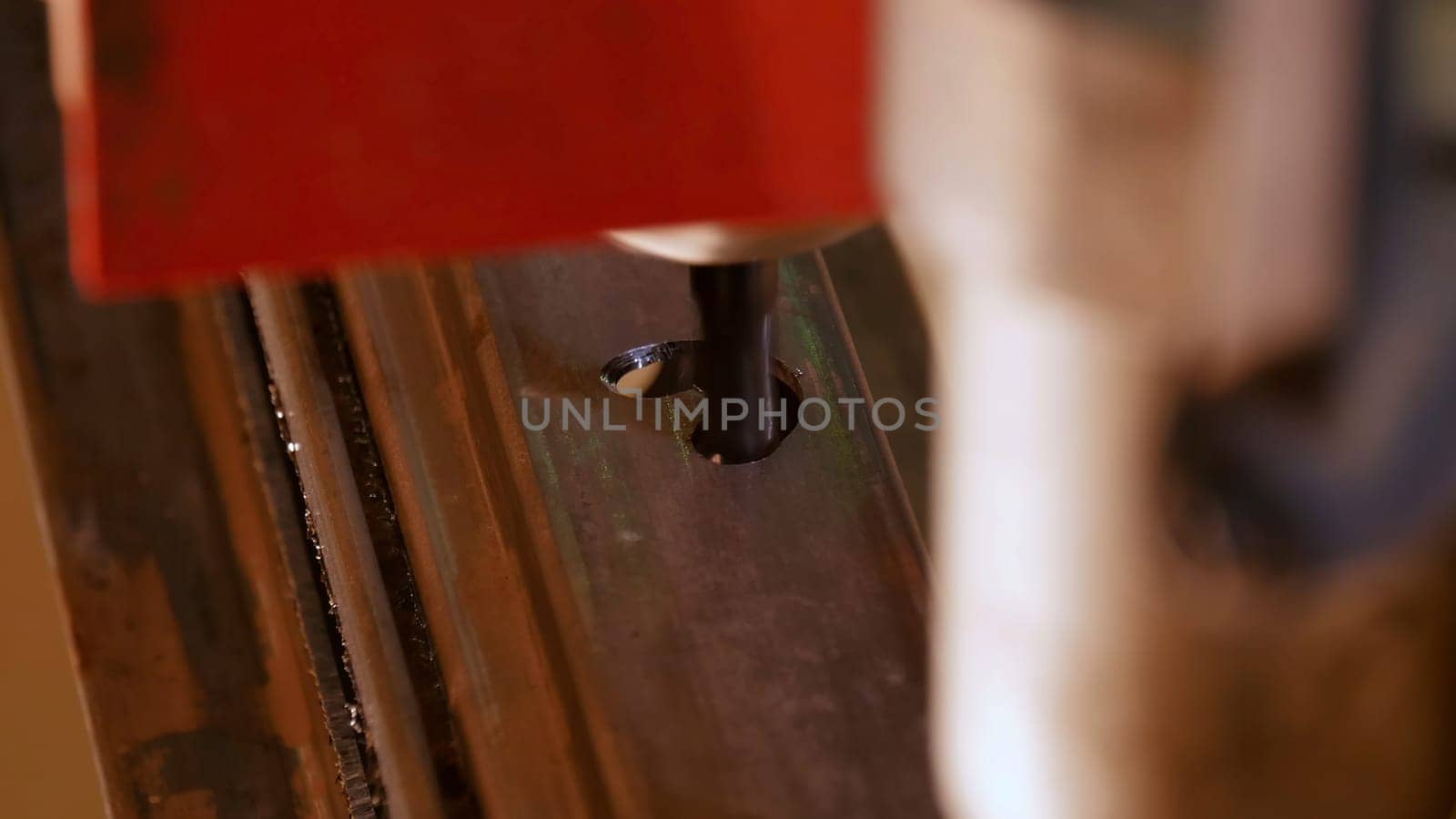 Close up of machine making holes in a wooden plank. Media. Automatic dremel machine on wood