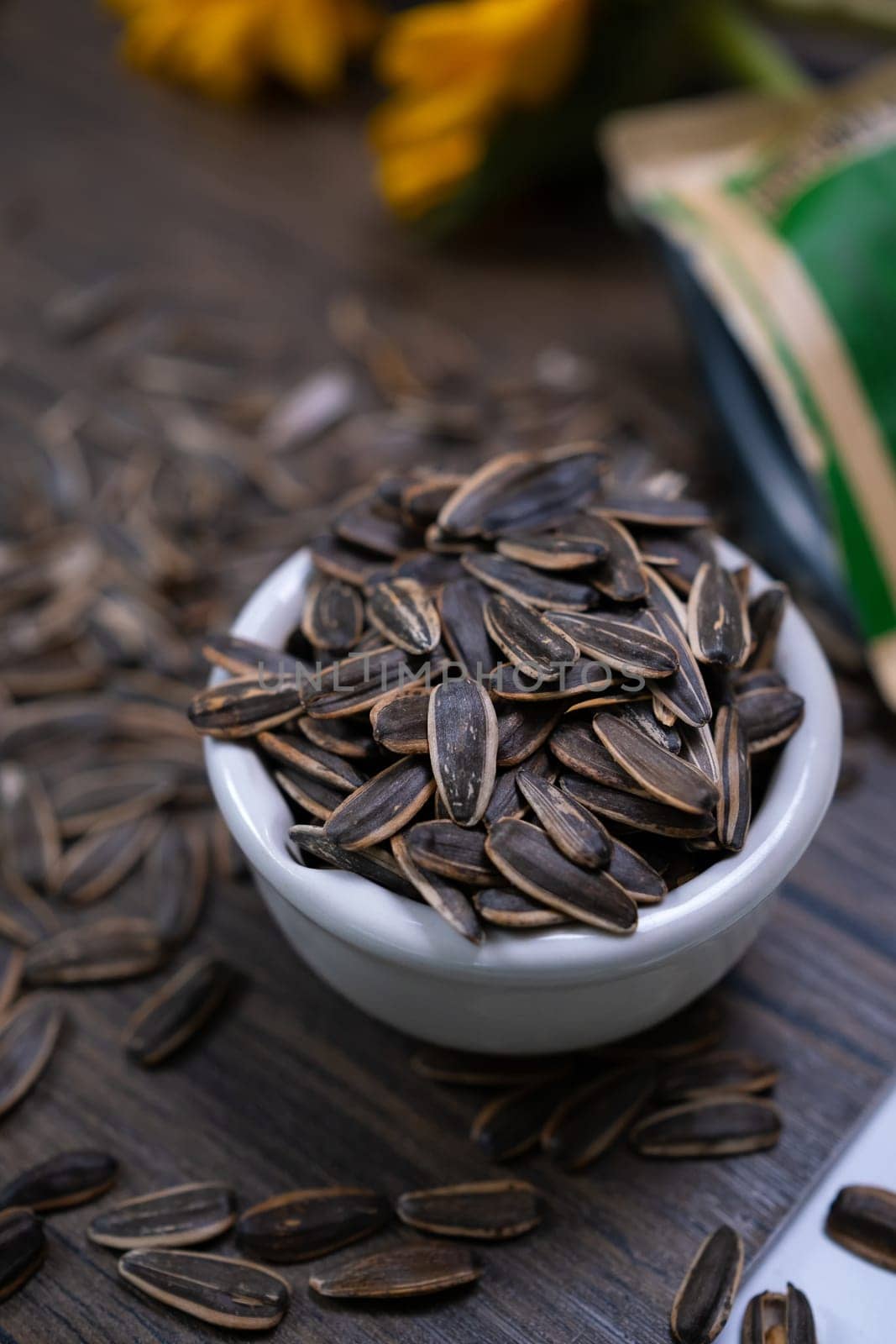 Organic sunflower seeds on rustic wooden table. Healthy eating, snacks concept.