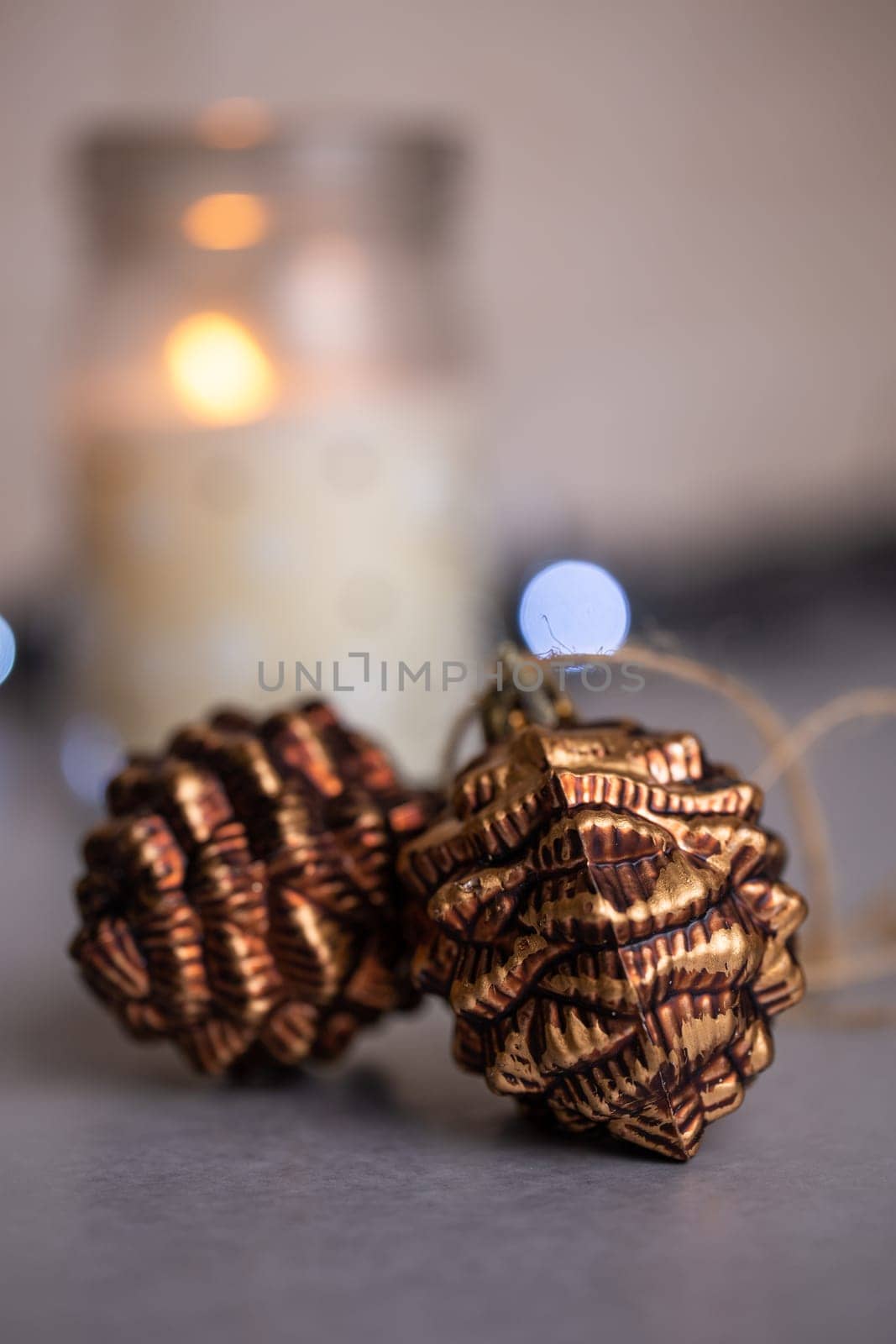 Close-up of a Christmas decorative composition with fir cones, candles and decor. New Year, Christmas background