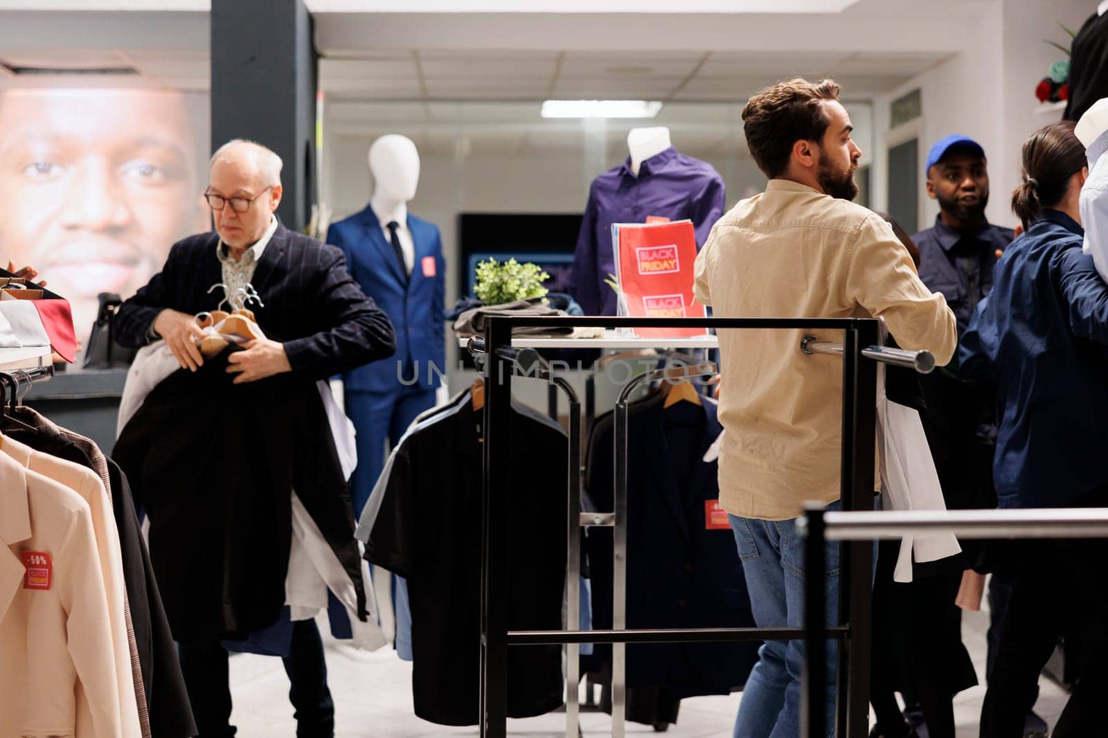 People shoppers looking for deals in local clothing store during Black Friday sales, obsessed customers grabbing clothes at discounted prices, hunting for bargains in fashion outlet. Bargain hunting