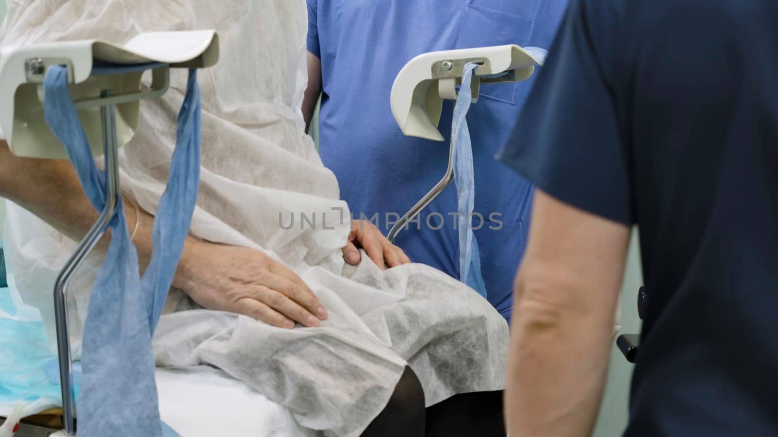 Surgical operation. Creative. A bright large room where surgeons can be seen performing surgery on people dressed in special hospital clothes for convenience. High quality 4k footage