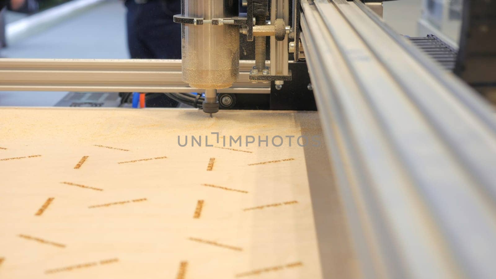 Industrial Wood Carving Machine. Media. Automated machine cutting patterns on wood. Wood cutting on industrial automated machine.
