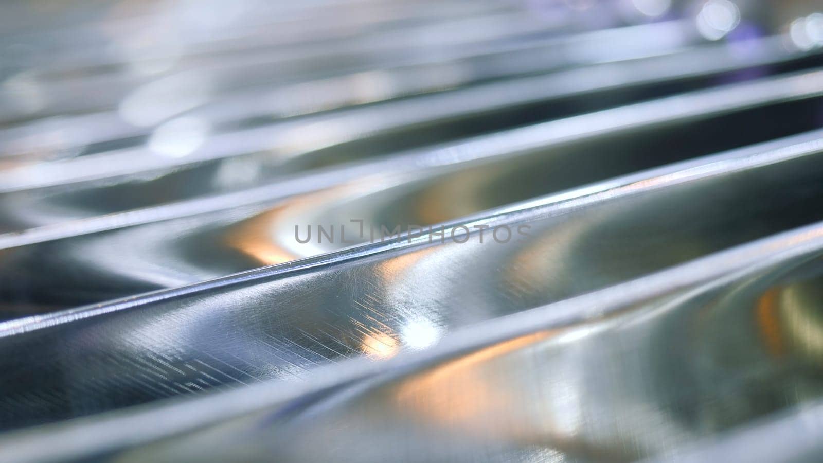 Close-up of metal grid of generator. Media. Lines of steel grid in generator coil. Metal grating strips of production machine.