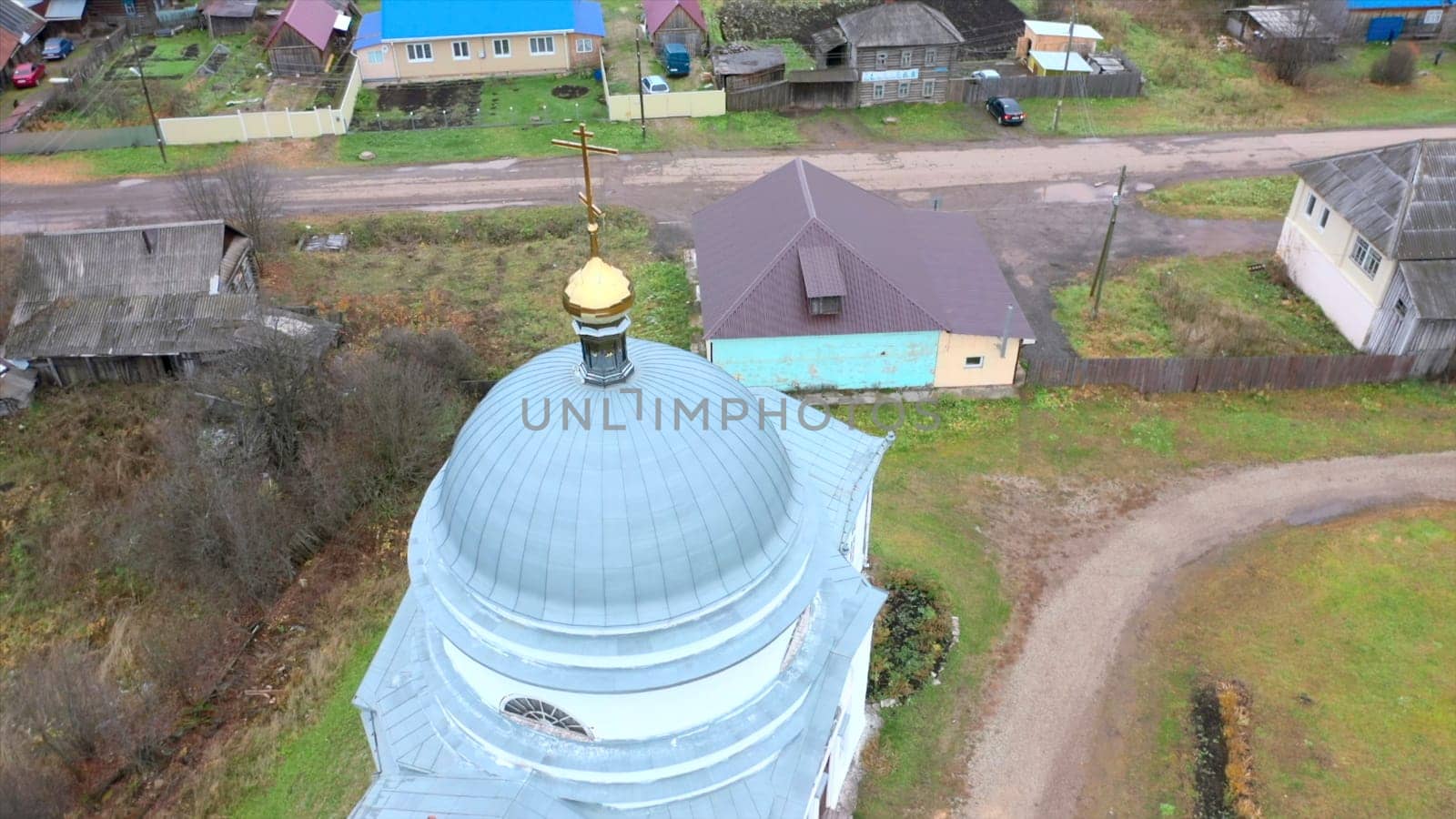 Top view of church in village. Clip. Church in small old village in summer. Small church in dirty old village with wooden houses.