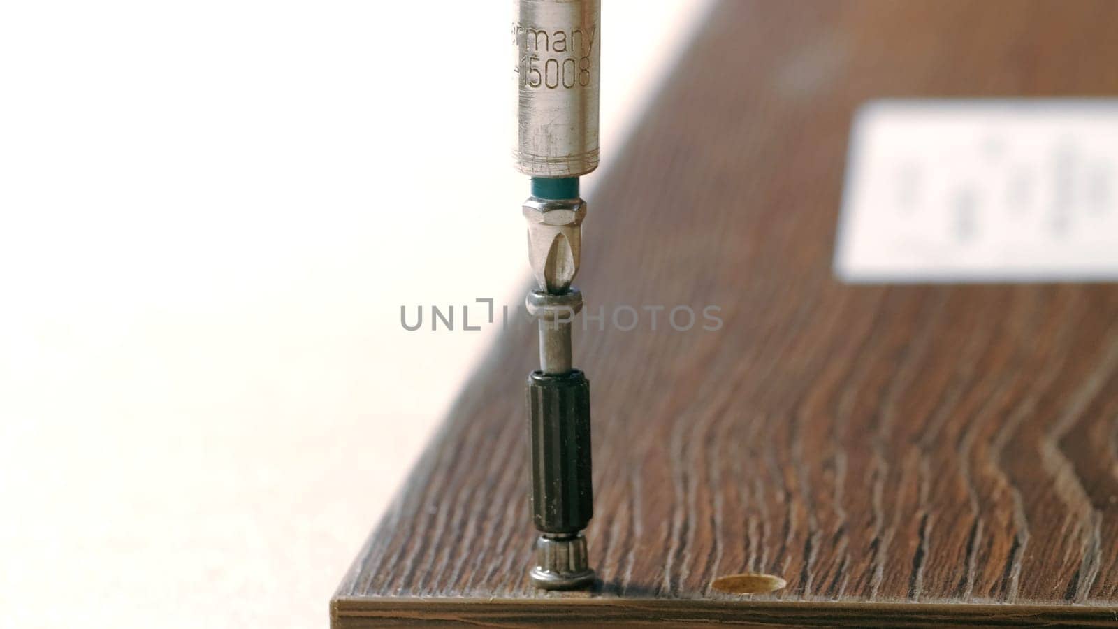 Repair work. Creative.A man collects a shelf by screwing bolts into it. High quality 4k footage