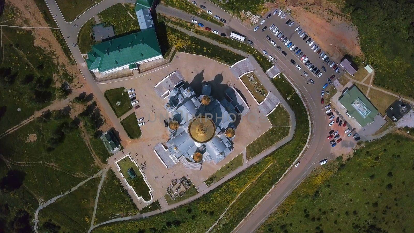 Vertical view of church from above. Clip. Top view of golden domes of church and surrounding area. Flat top view of church in summer.