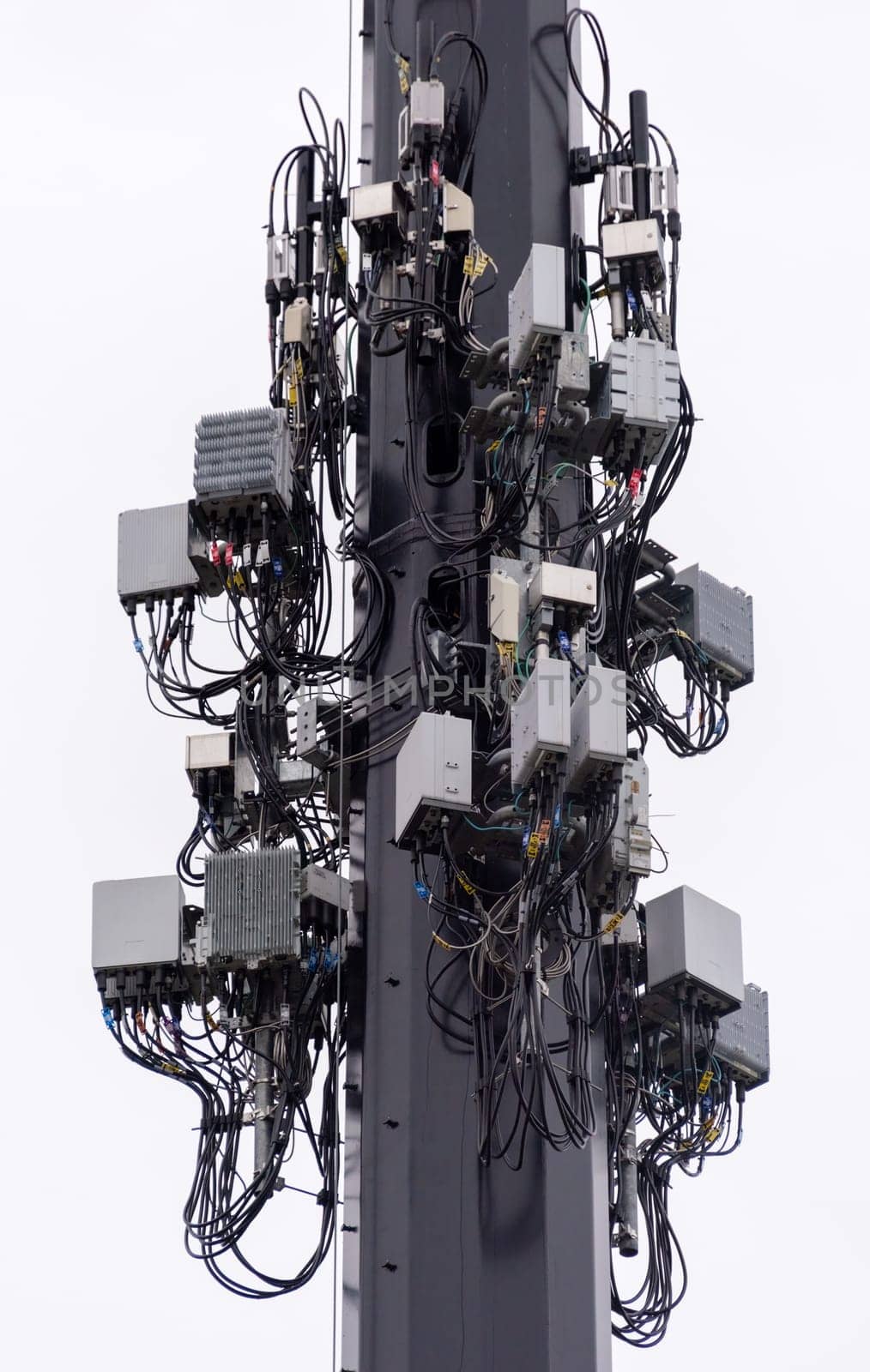Wireless communication equipment mounted on big lightening pole. Isolated subject on white