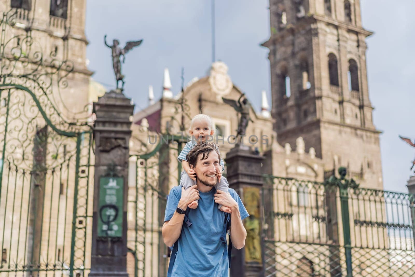 Father and son tourists in front of Catedral de Puebla, Mexico. Travel, cultural heritage, and historic architecture exploration concept.