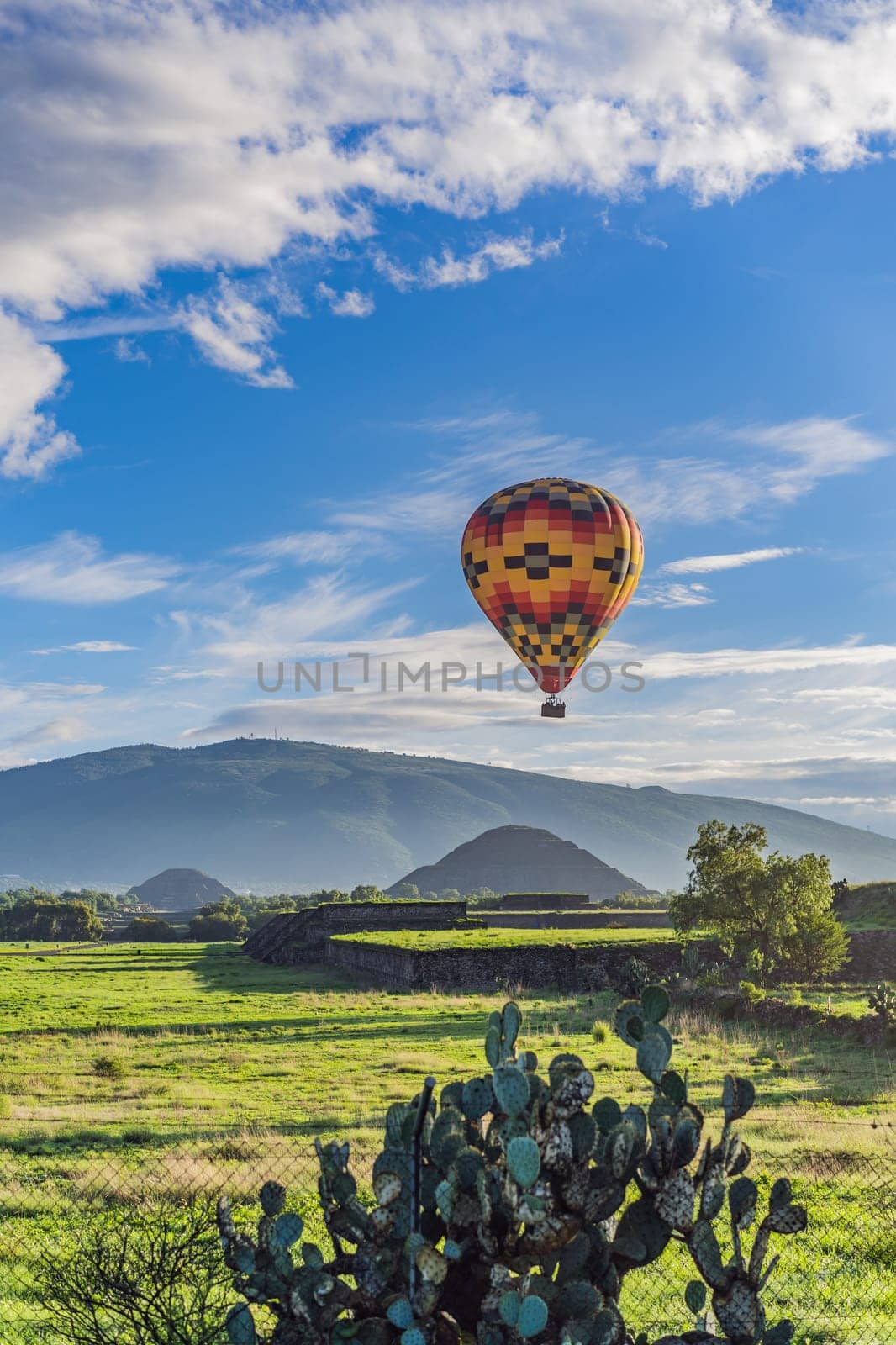 An aerial view of hot air balloons above the Teotihuacan pyramid. Adventure travel, cultural heritage, and aerial exploration concept.