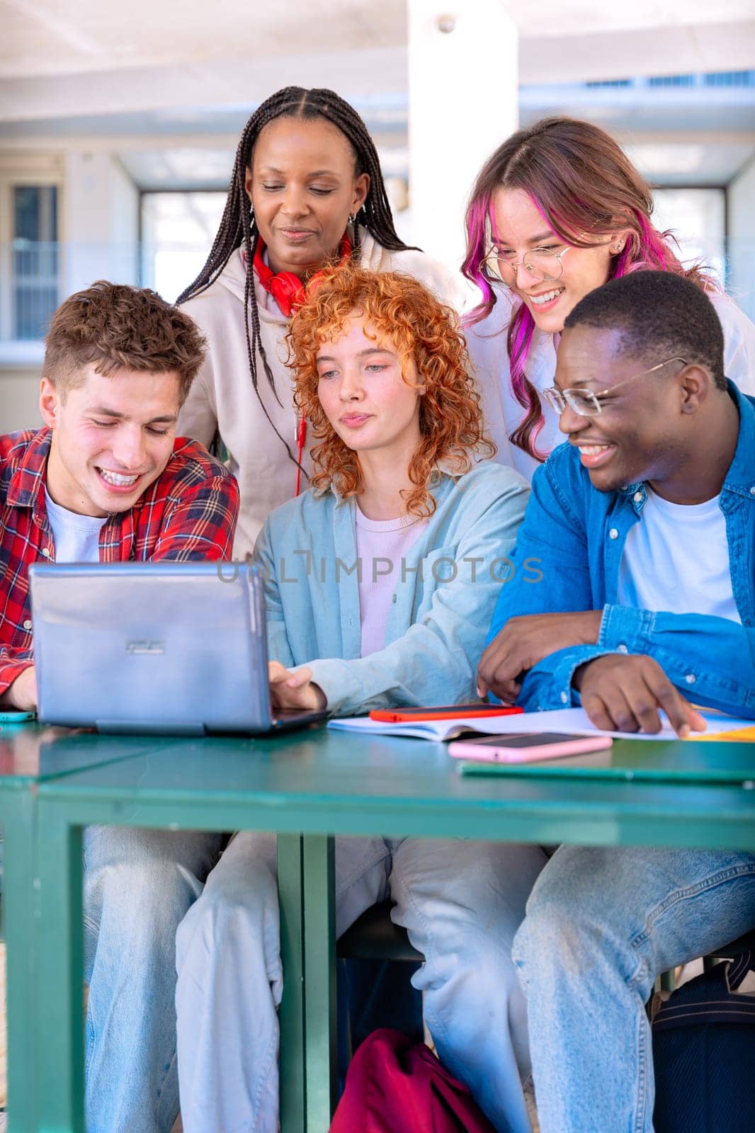 Group of students, meet on university campus work together on creative tasks, prepare for university exams, use laptop. Education, study of university life concept.