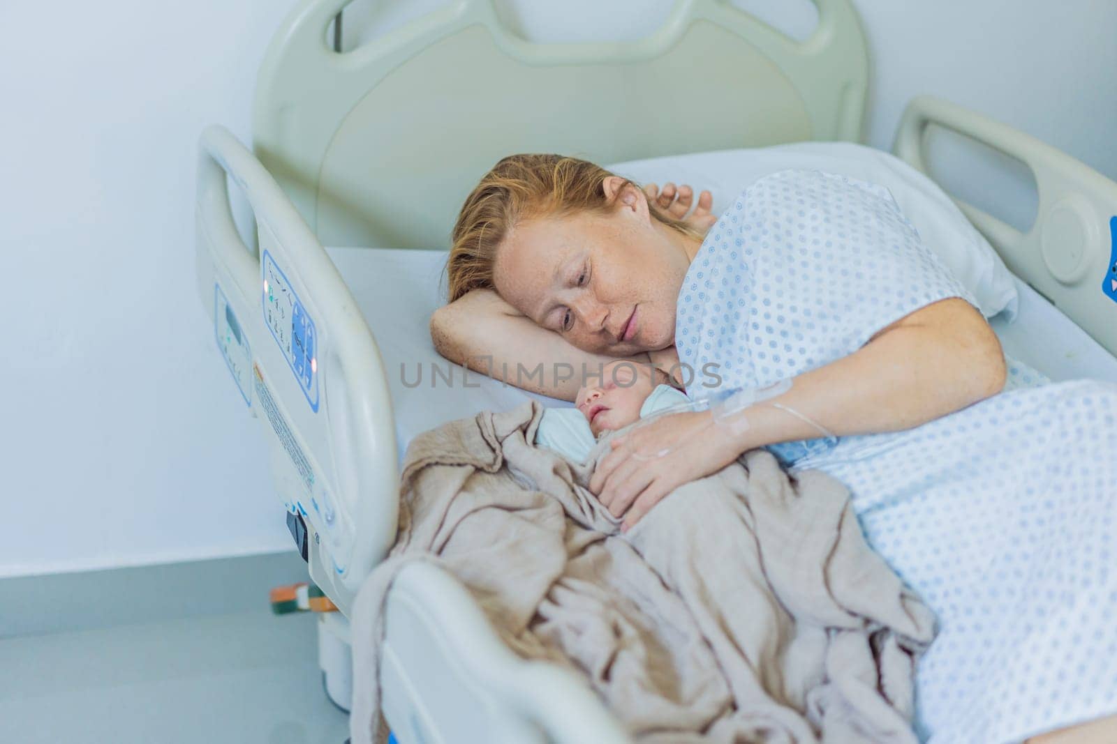 A baby lies with the mother after childbirth, resting peacefully. The serene moment captures the bond between mother and child as they begin their journey together. The hospital environment ensures a safe and comforting space for this intimate interaction.