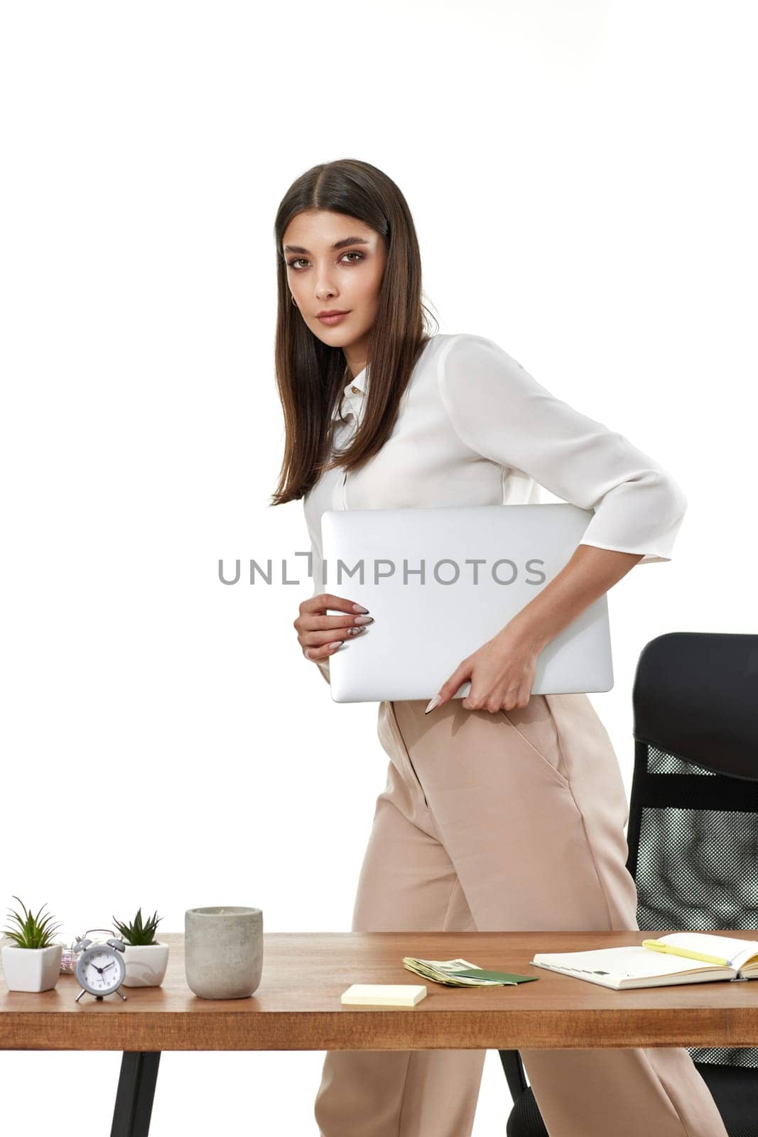 Young beautiful woman holding laptop computer. Businesswoman working in office.