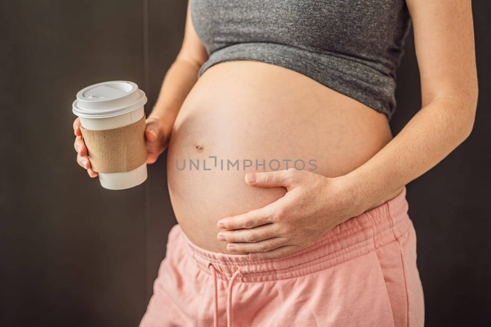 Pregnant woman with a paper cup of coffee. The benefits or harms of coffee for pregnant women.
