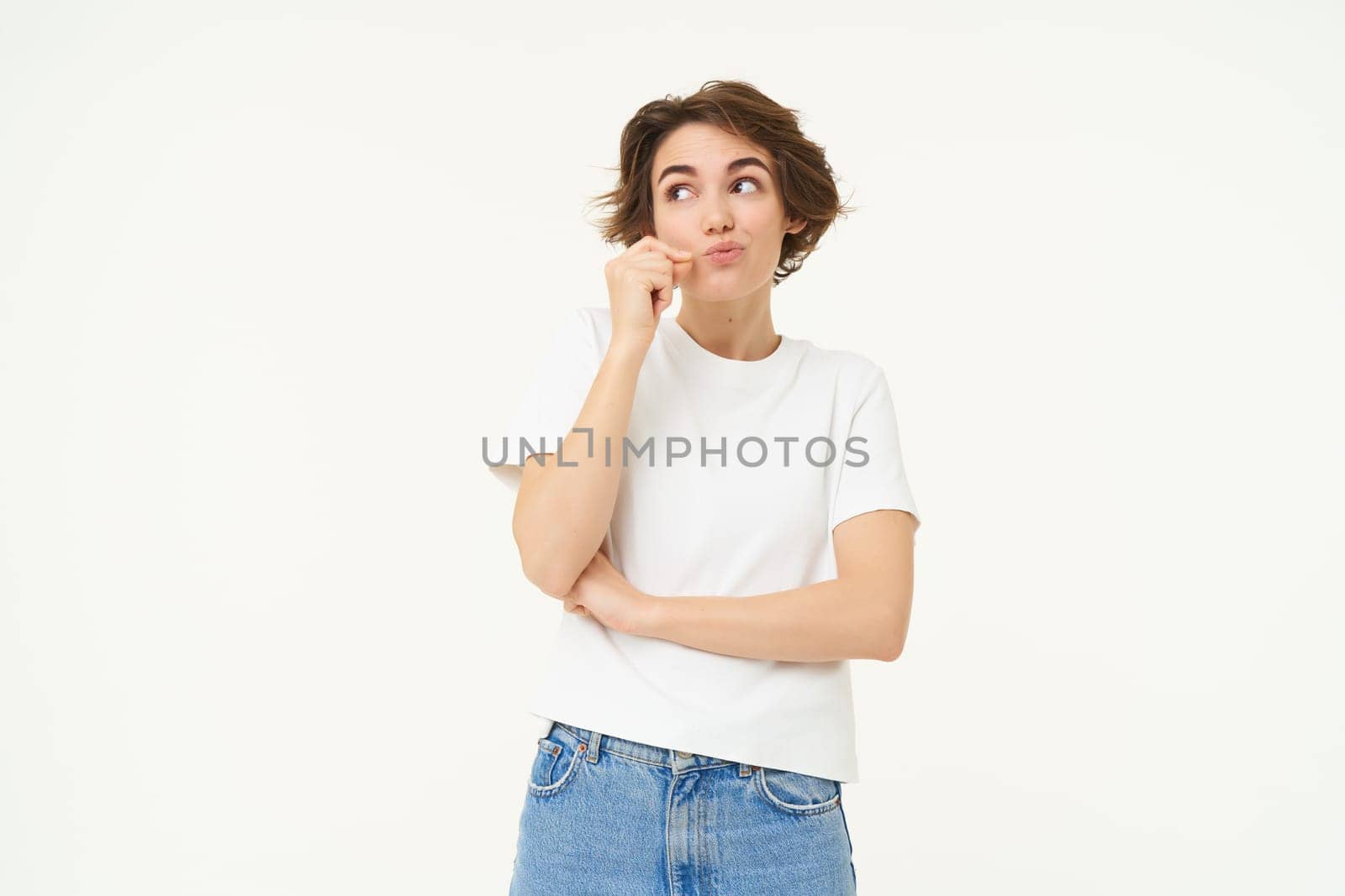 Young woman zips her mouth, keeps a secret, shuts lips on seal, makes promise, concept of taboo and gossips, stands over white background by Benzoix