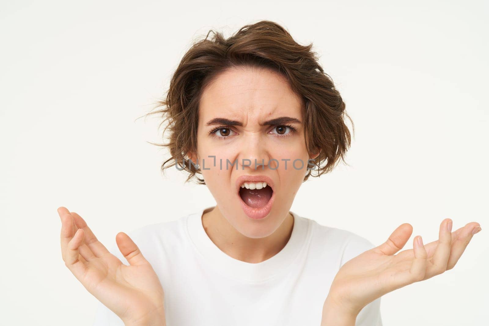 Close up of angru woman, looking shocked and frustrated, cant understand something, standing over white background by Benzoix