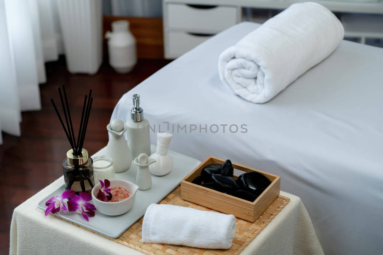 Exquisite display of beauty treatment and spa salon accessories arranged on spa table in luxury spa resort. Relaxing spa massage and recreation background concept. Quiescent