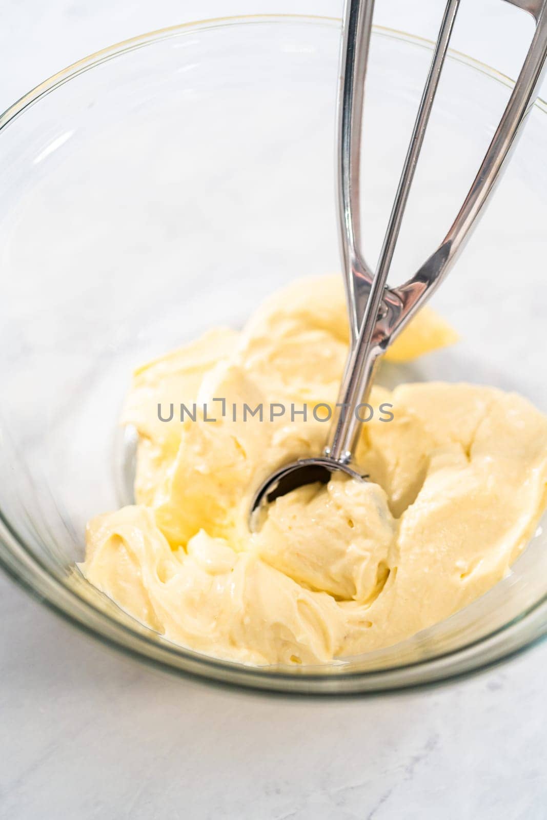 Filling metal bundt cake pan with cake butter to bake red velvet bundt cake with cream cheese glaze