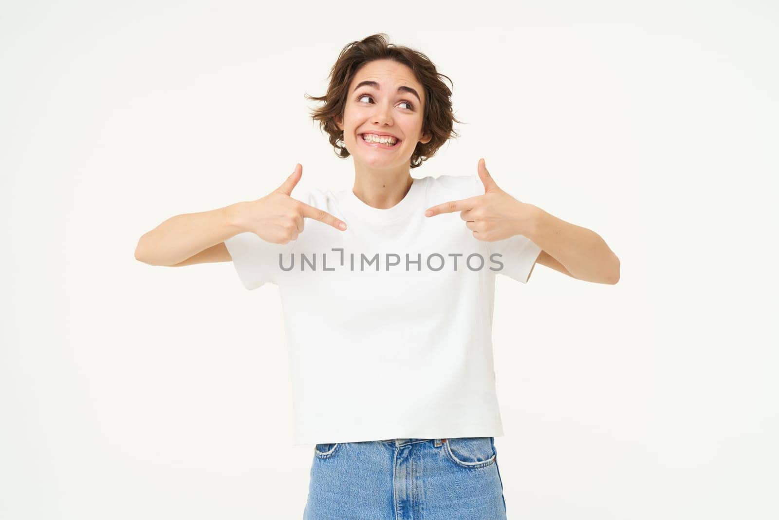 Image of confident, happy young woman, pointing at herself with smiling face, self-assured, standing over white background by Benzoix