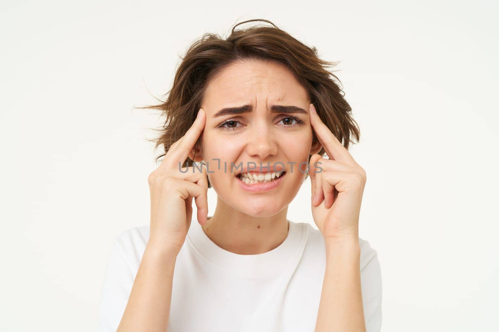 Image of woman in panic thinking, brainstorming, trying hard to remember something, standing over white background.