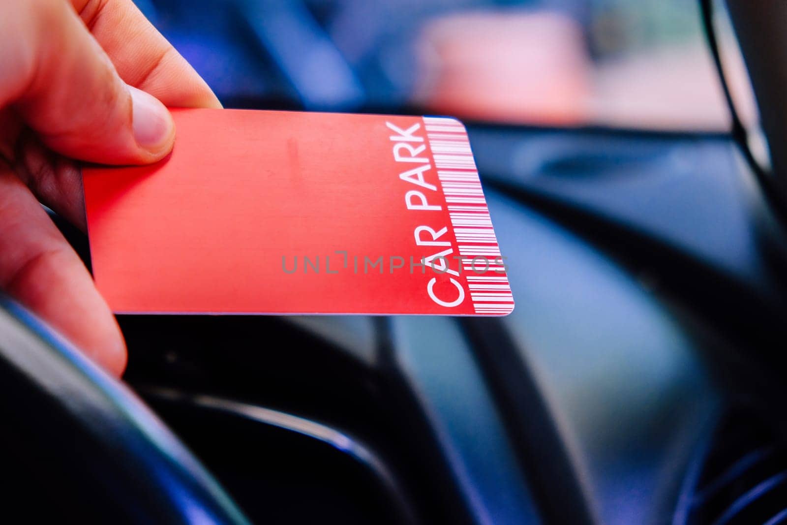 Driver is holding parking card getting ready to exit parking