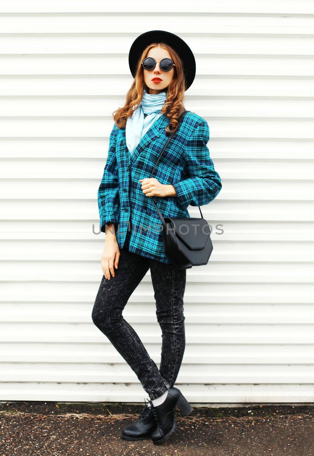 Fashion young woman model wearing black hat checkered coat jacket handbag on white background