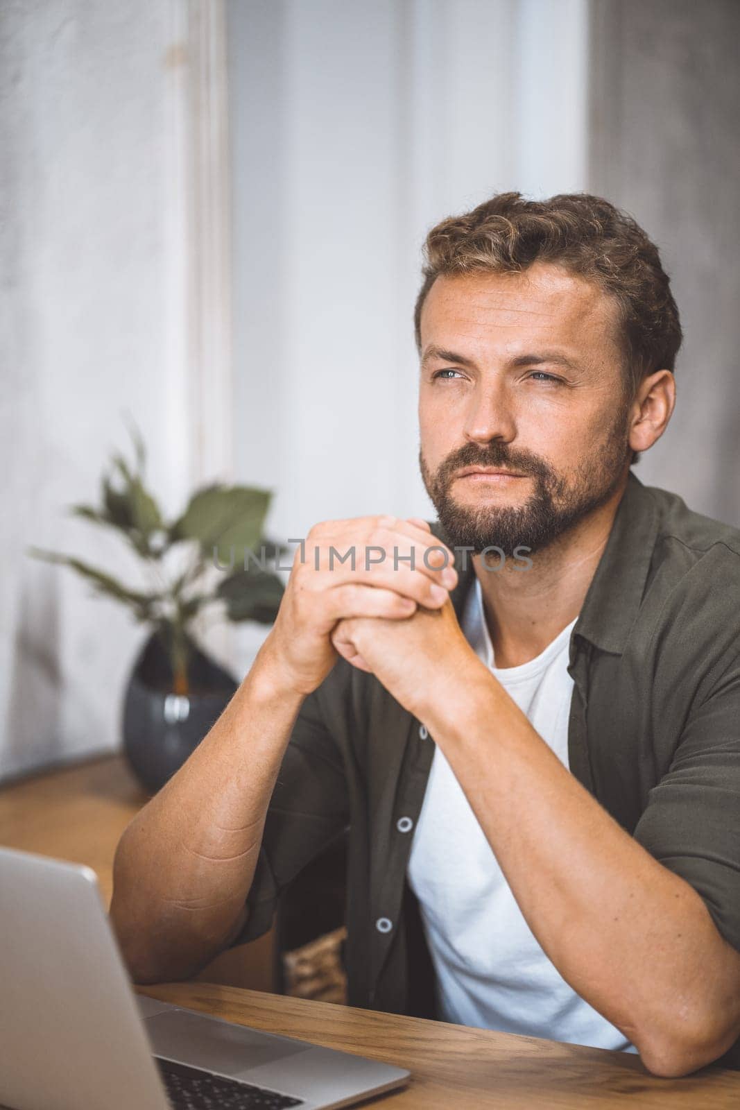 A man sitting in front of a laptop computer.