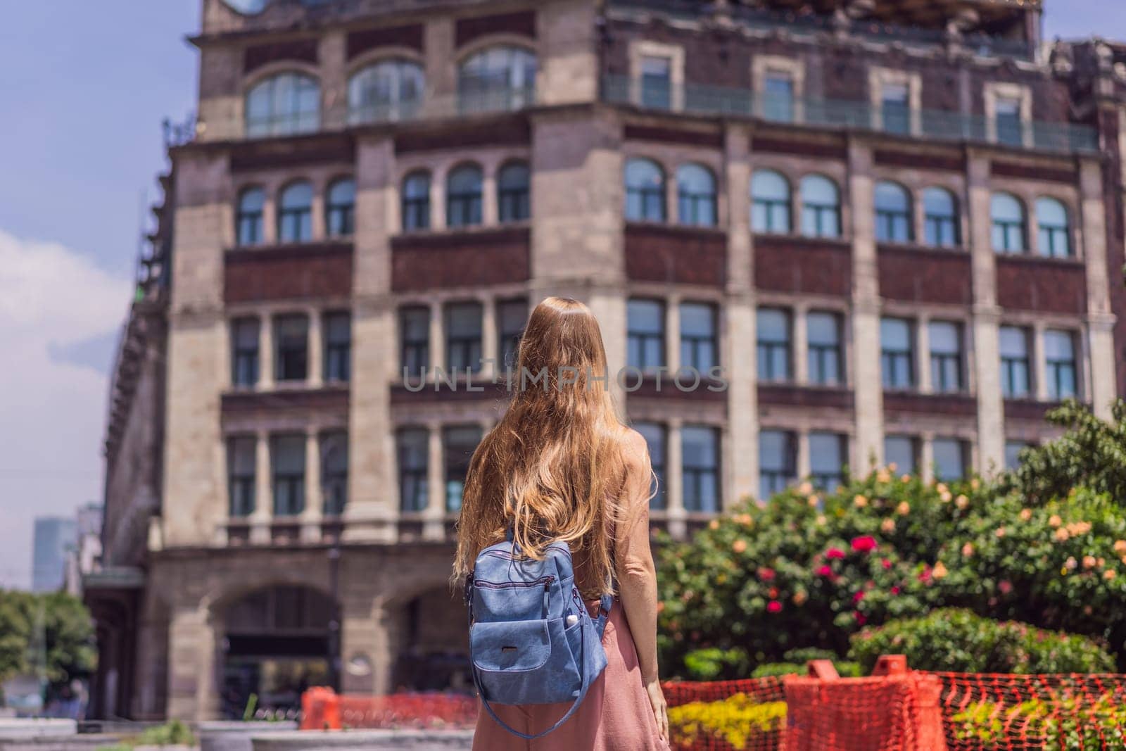 Female tourist in the central square of Mexico City, Zocalo. Cultural exploration, travel, and historic architecture concept.