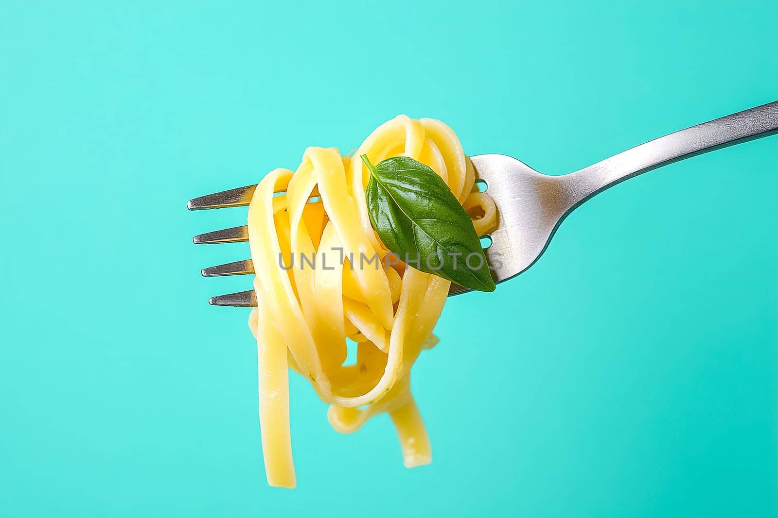 A fork lifts a swirl of fettuccine pasta, adorned with a single green basil leaf, set against a vibrant turquoise backdrop for a fresh, appetizing look.