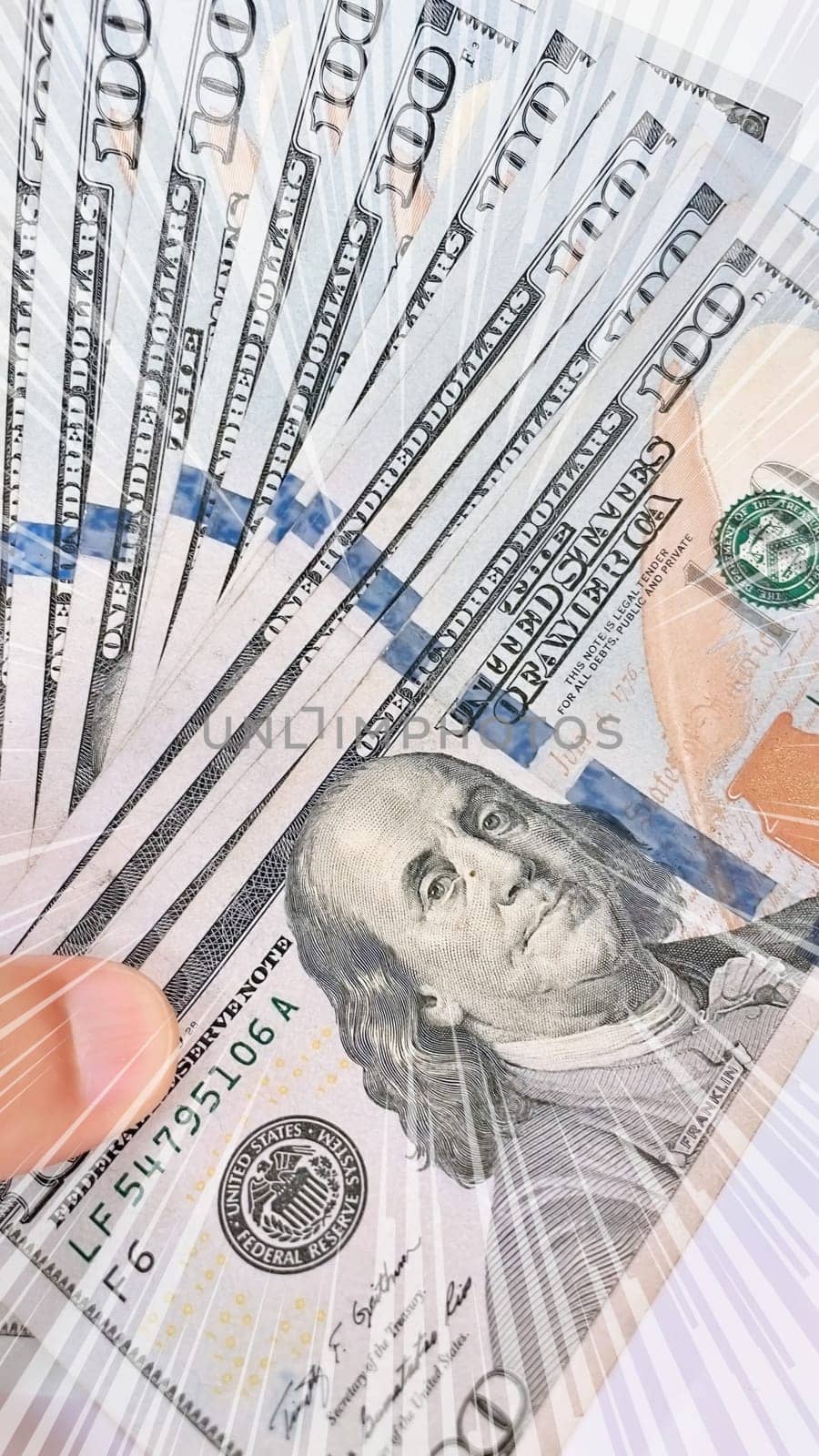 A Fan of $100 Bills.A close-up photo of a fan of $100 US dollar bills. The bills are arranged neatly, with the portrait of Benjamin Franklin visible on each bill. The background is white.Finance ve economy concept.