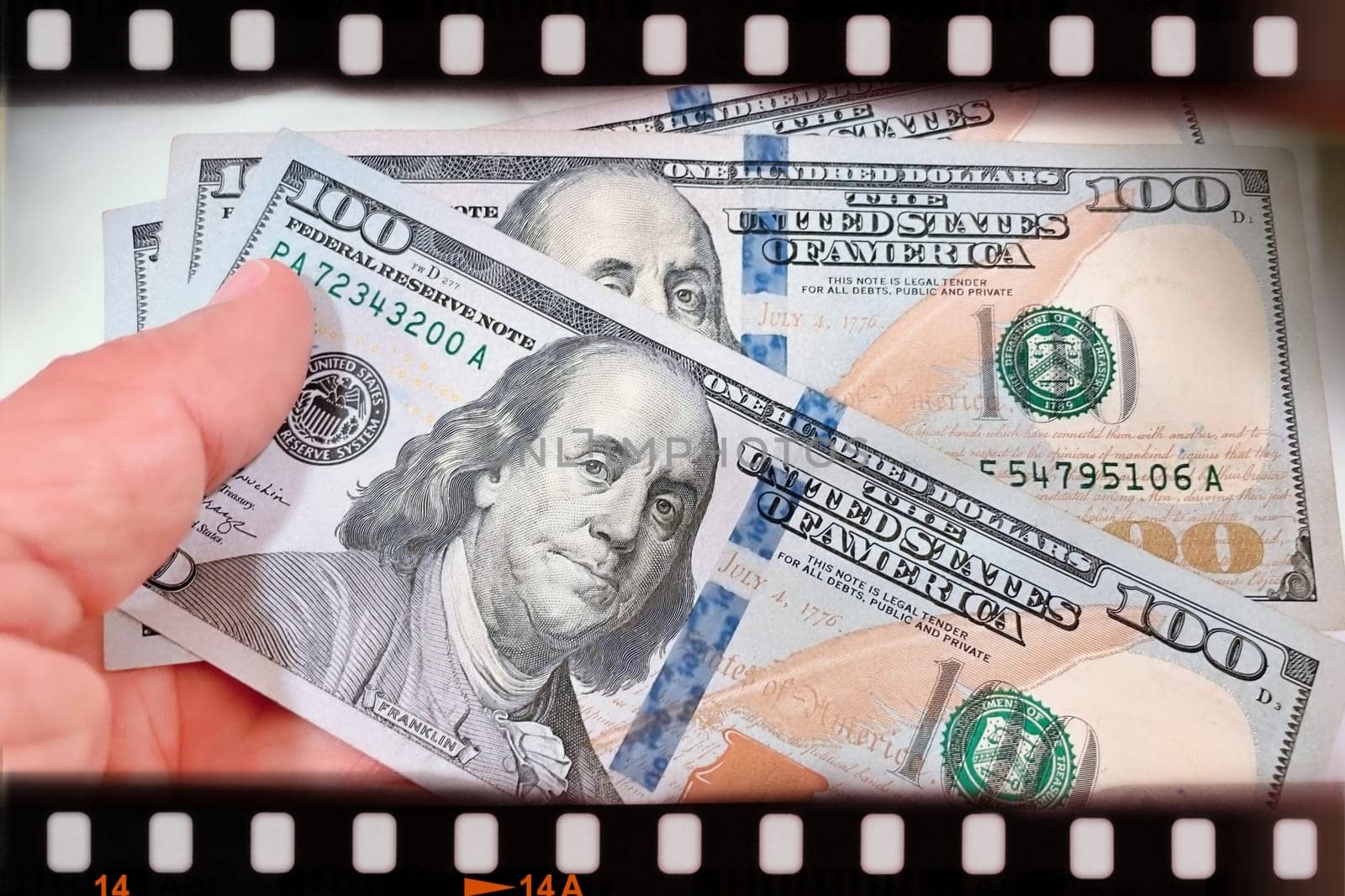 A Fan of $100 Bills.A close-up photo of a fan of $100 US dollar bills. The bills are arranged neatly, with the portrait of Benjamin Franklin visible on each bill. The background is white.Finance ve economy concept.